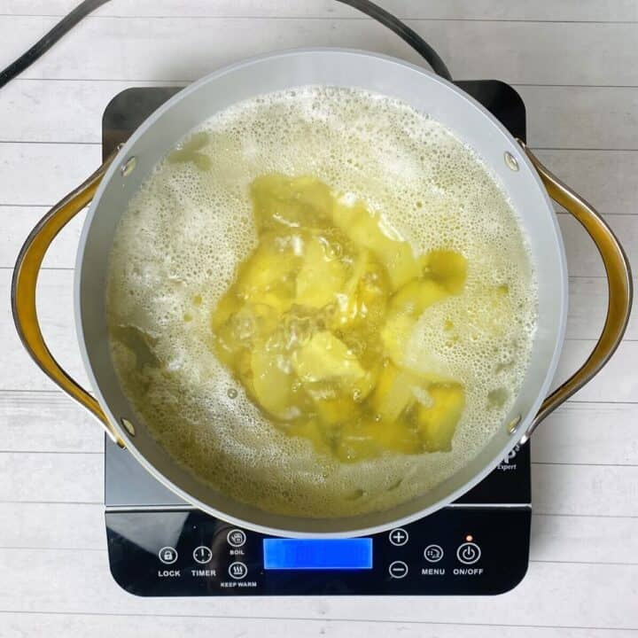 A pot of potatoes in boiling water.