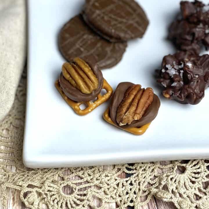 A close up of pecan turtle treats on a plate.