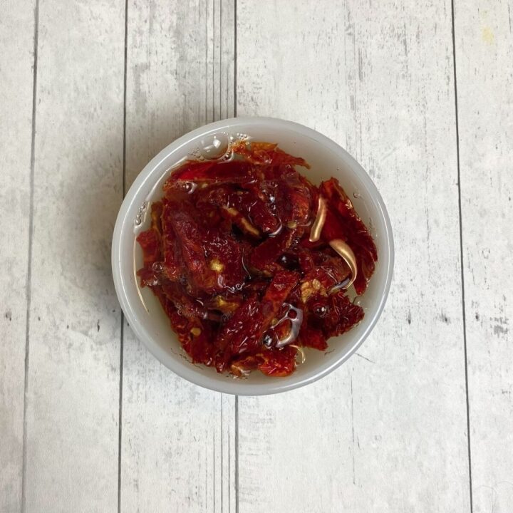 A bowl with sundried tomatoes soaking in hot water.