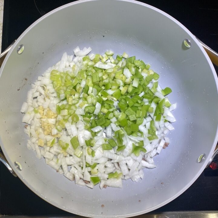 A pot sautéing vegetables.