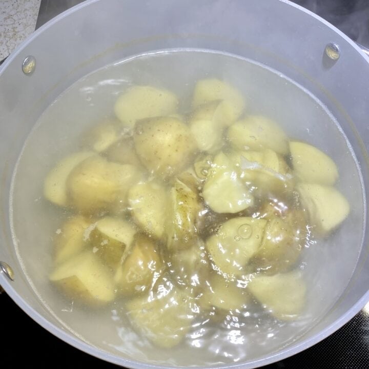 Potatoes boiling in a pot.