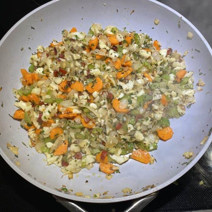 A non-stick pan with cooked vegetable ingredients.