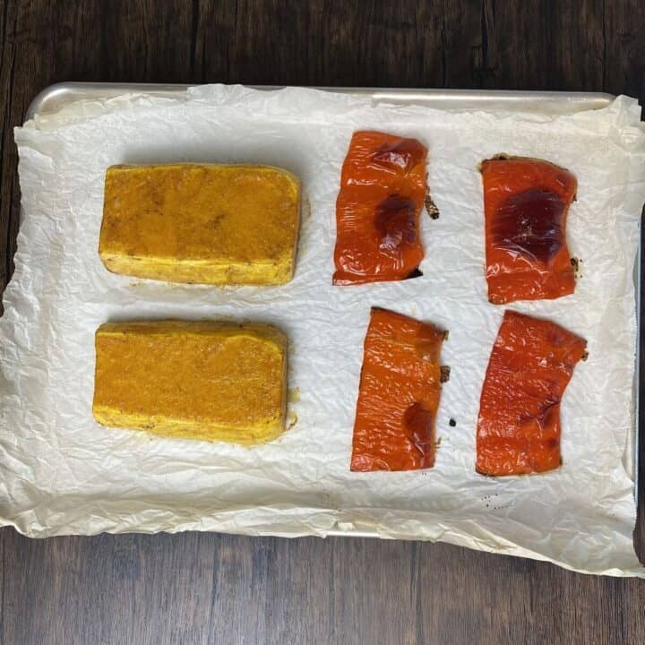Squash and bell pepper roasted on a parchment lined sheet pan.
