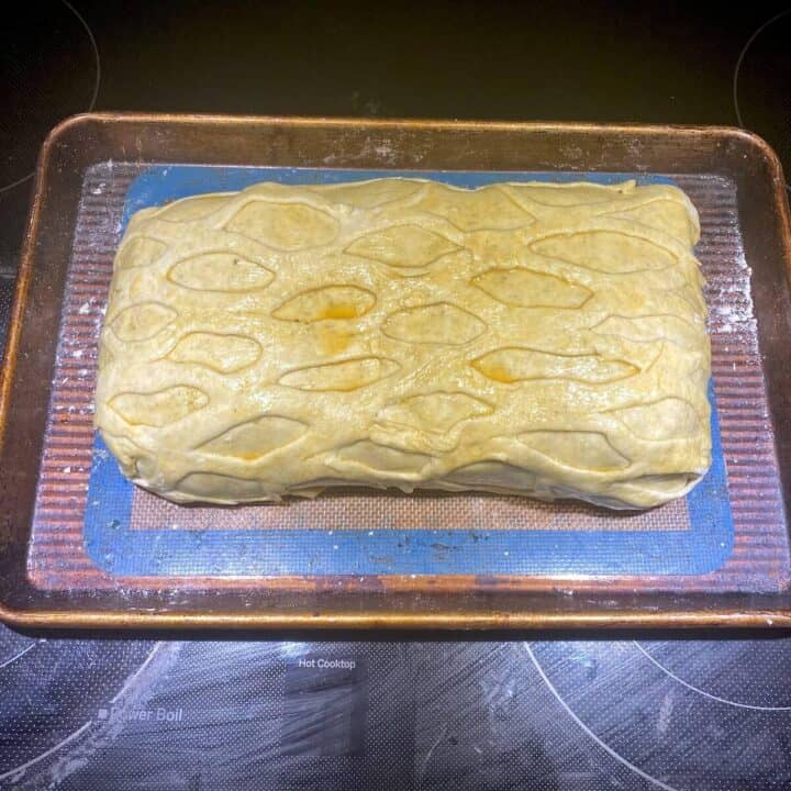 A vegetable wellington unbaked on a sheet pan.